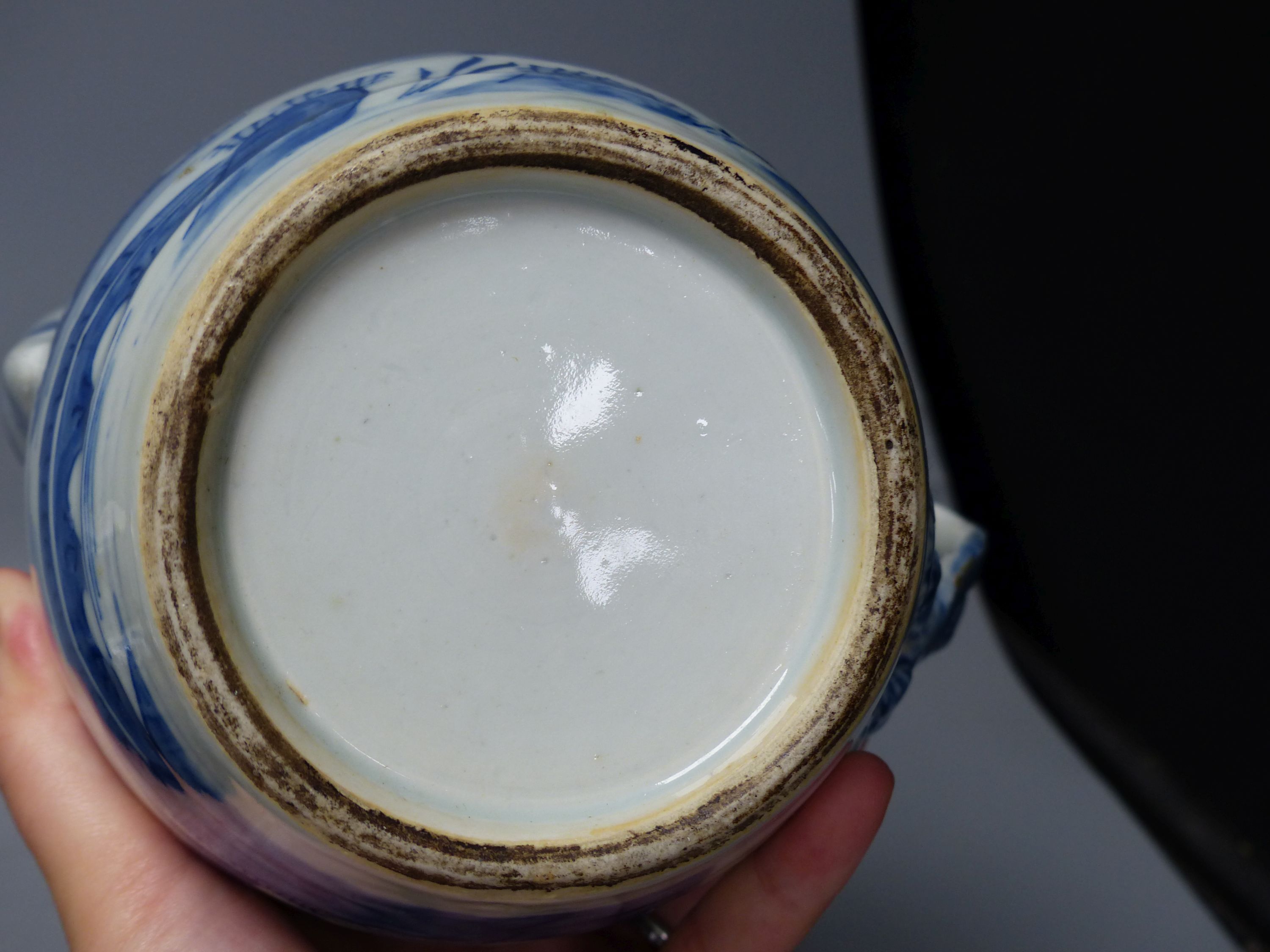 A 19th century Chinese blue and white covered jug, an early 20th century blue and white vase and a Kangxi rouge de fer teapot, tallest 18cm